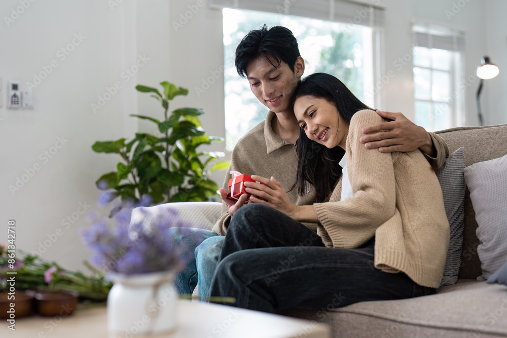 Happy Couple Enjoying Quality Time Together at Home in a Cozy Living Room Setting Happy Couple Enjoying Quality Time Together at Home in a Cozy Living Room Setting