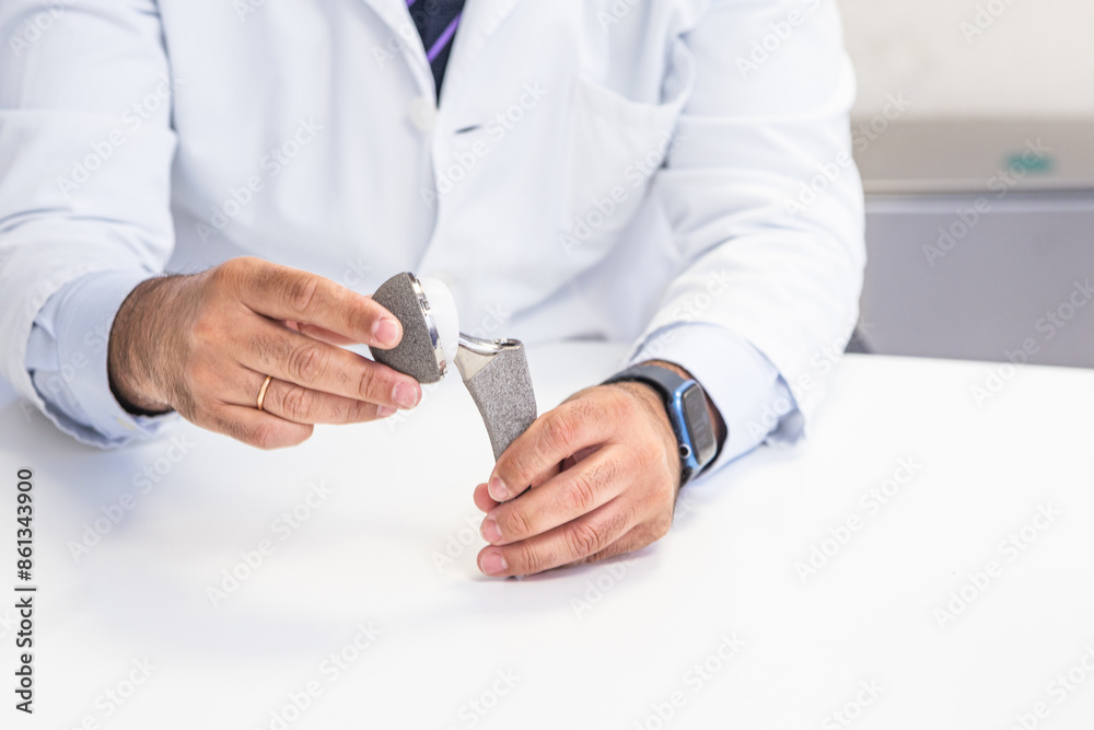 Orthopedic Surgeon Demonstrating Hip Prosthesis Orthopedic Surgeon Demonstrating Hip Prosthesis