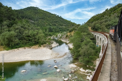 The steam train of the Cevennes, old train in a french landscape, on the river
