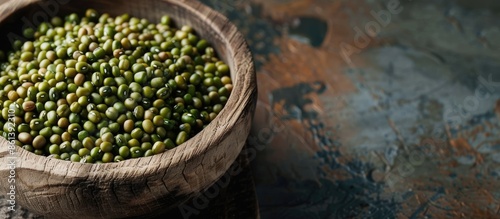 Close-up of dried mung beans in a wooden bowl with copy space image. photo