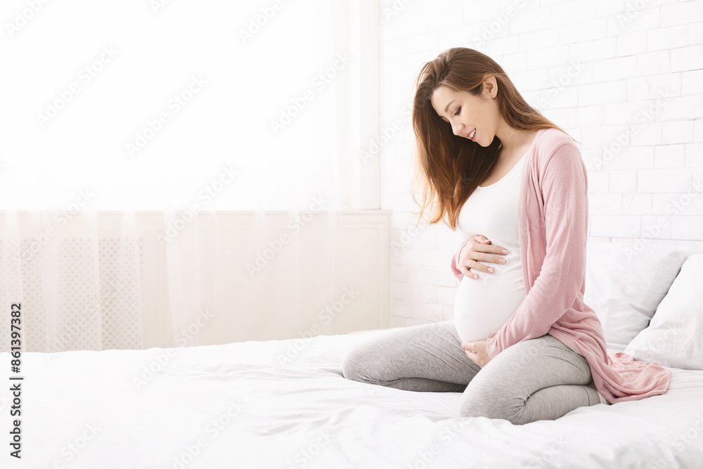 Pregnant woman happy during pregnancy in bedroom. Happiness and feeling joyful as emotional well affect to baby neurological and psychological development, empty space Pregnant woman happy during pregnancy in bedroom. Happiness and feeling joyful as emotional well affect to baby neurological and psychological development, empty space