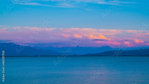Obraz na płótnie Germany, Warm sunset light on alps mountains nature landscape behind silent water of bodensee lake after sunset, panorama view from lindau w salonie