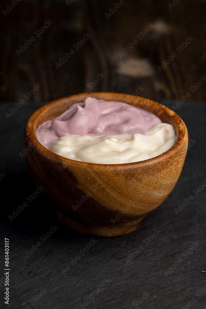 vanilla and raspberry flavored yogurt in a wooden bowl