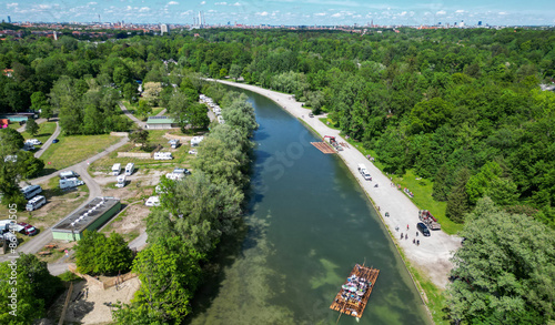 The Isar river flows into the city of Munich aerial view. Isar raft trips with Isar raft event