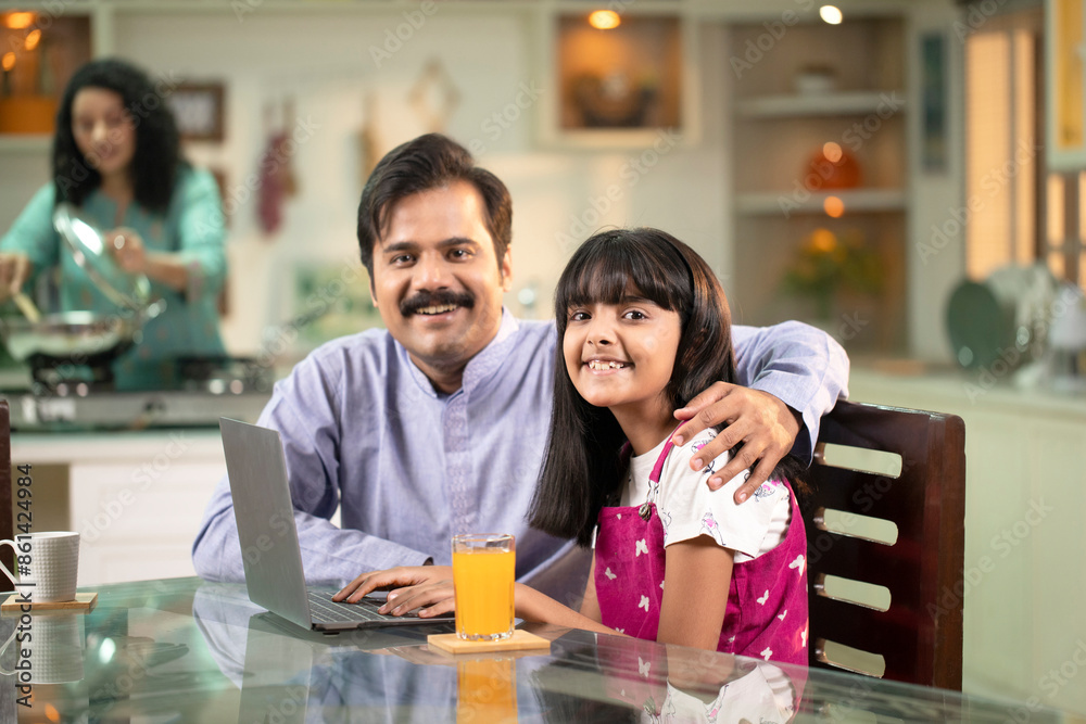 Handsome Daddy And Daughter Sitting At Dining Table While Posing In Front Of Camera Handsome Daddy And Daughter Sitting At Dining Table While Posing In Front Of Camera