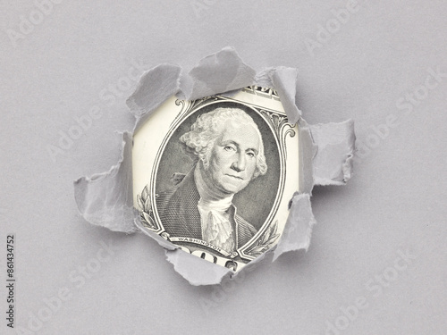 us dollar in the hole of grey paper