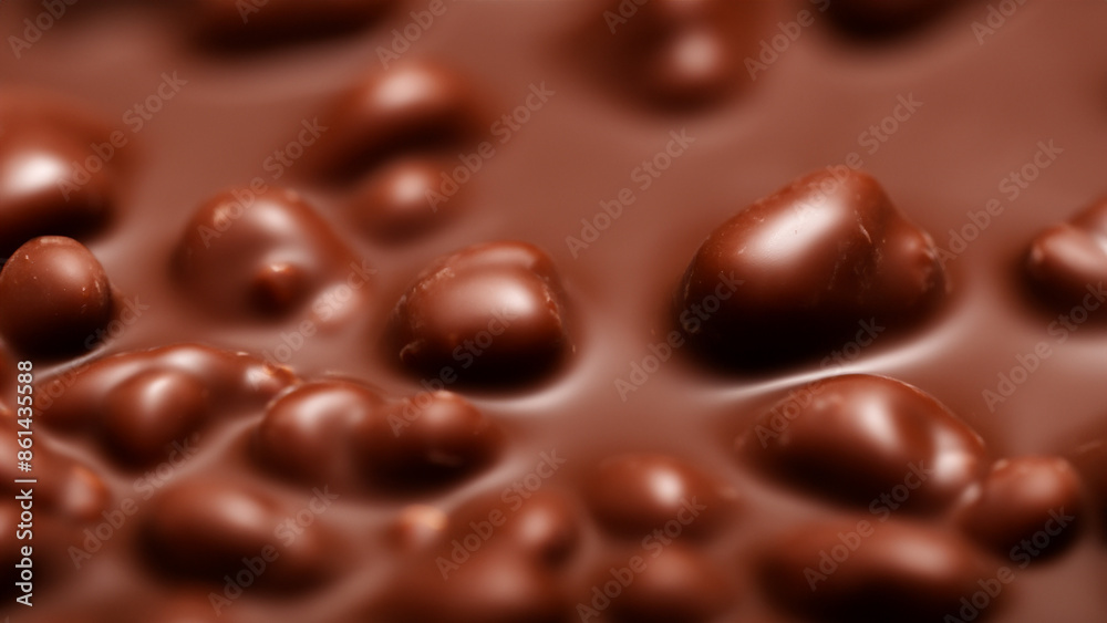 Close-up of a chocolate bar with nuts, showcasing its smooth texture and rich brown color.