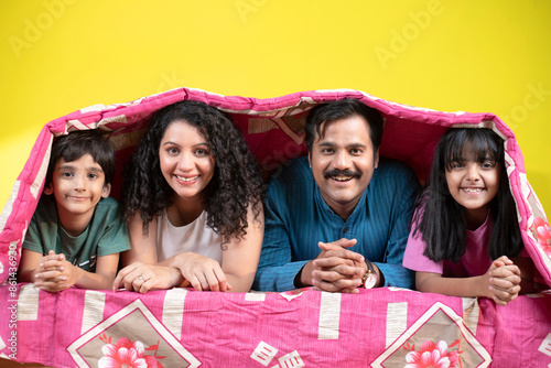 Indian Family Under Blanket At Home photo