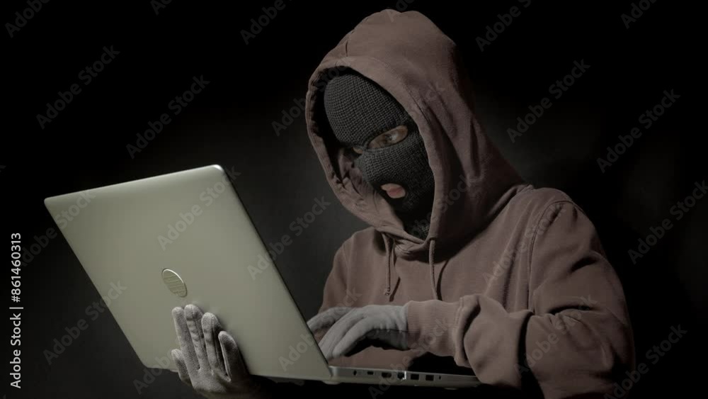Computer hacker steals data from laptop by hacking security system, identity theft and computer crime. Hidden hacker. Cyber concept. Computer hacker steals data from laptop by hacking security system, identity theft and computer crime. Hidden hacker. Cyber concept.
