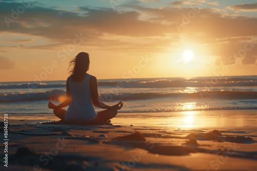 A woman meditates on the beach during sunset, peace and health