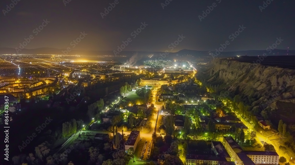 Fototapeta premium City lights illuminate a valley at night