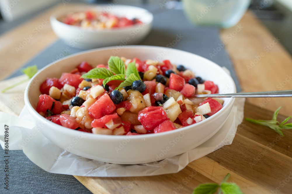 Homemade food with a fresh fruit salad. Made with melon, banana, apples, kiwi and blueberries in a bowl Homemade food with a fresh fruit salad. Made with melon, banana, apples, kiwi and blueberries in a bowl