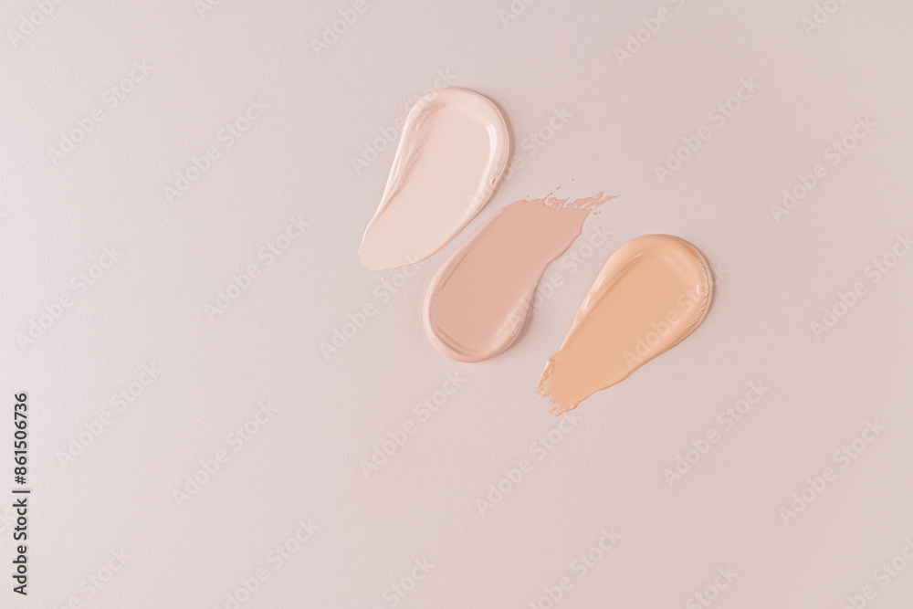 Three beautiful samples of foundation powder of different tones on a beige background with a copy space. Delicate texture of foundation . top view. Three beautiful samples of foundation powder of different tones on a beige background with a copy space. Delicate texture of foundation . top view.