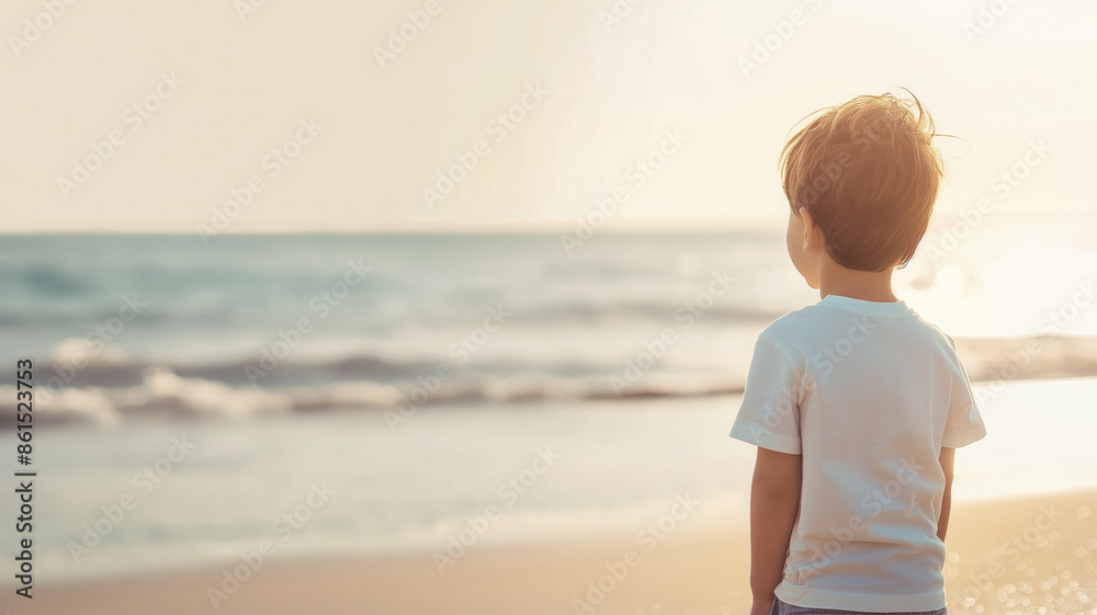 Young child standing on beach looking at ocean during sunset. Peaceful moment capturing childhood wonder and serenity Young child standing on beach looking at ocean during sunset. Peaceful moment capturing childhood wonder and serenity
