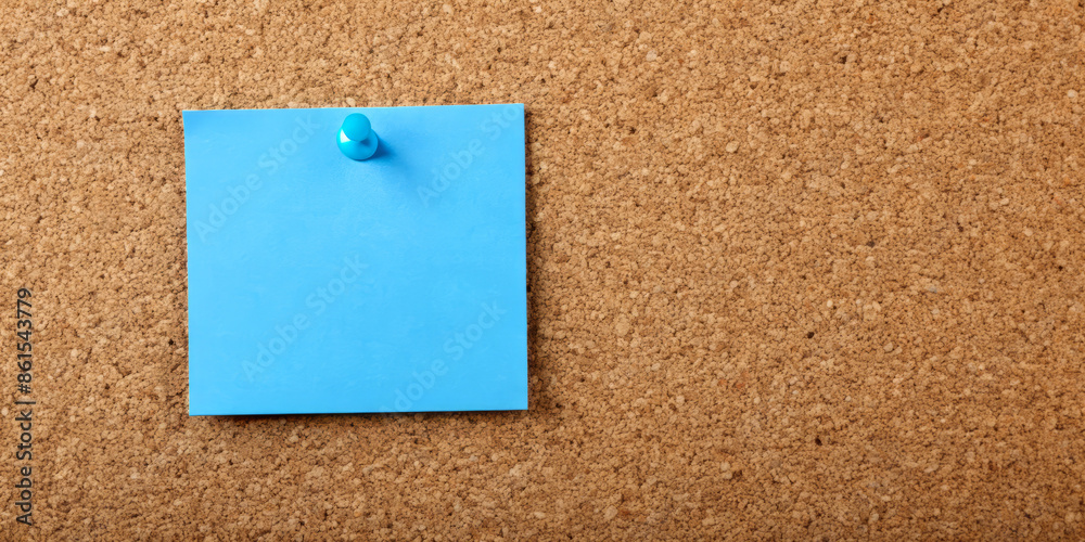 Blue sticky note pinned on a cork board, close-up showing the texture of the board and the bright blue color of the note, ideal for reminders or messages. Blue sticky note pinned on a cork board, close-up showing the texture of the board and the bright blue color of the note, ideal for reminders or messages.