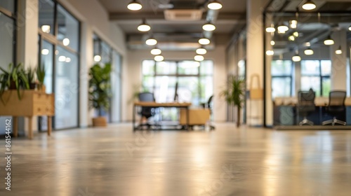 A contemporary office features an open layout with modern wooden furniture, abundant natural light, and green potted plants enhancing the ambiance for optimal teamwork and productivity.