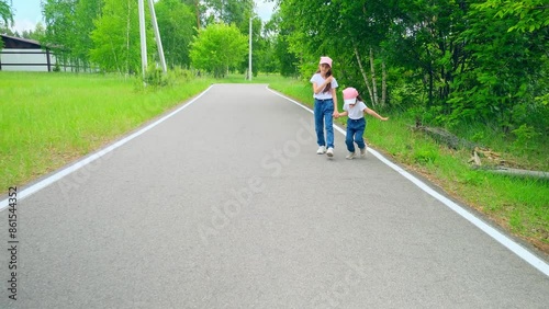 Wallpaper Mural Friendly family walking holding hands in the park in summer. Happy sisters enjoys running on nature forest together on vacation. Torontodigital.ca