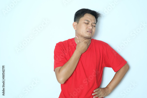 Young Asian man suffer sore throat. Wearing red t-shirt photo
