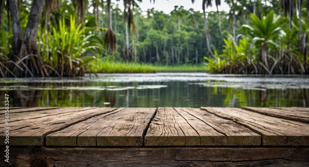 rustic wooden table and, in the background, a swampy jungle blurred with nature, swamp vegetation, and sky, to use as a background for products. rustic wooden table and, in the background, a swampy jungle blurred with nature, swamp vegetation, and sky, to use as a background for products.
