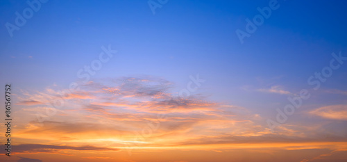 Fototapeta Naklejka Na Ścianę i Meble -  Sunset sky with golden sunlight and orange clouds on horizon blue evening sky background after sundown in panoramic view, Beautiful idyllic natural tranquil scene