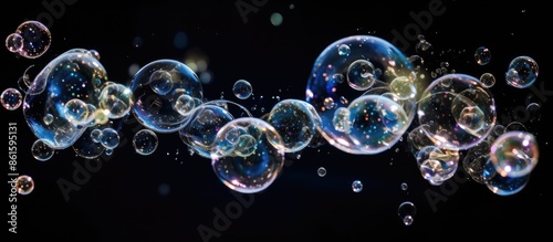Soap bubbles creating a frothy image with a dark background for copy space.