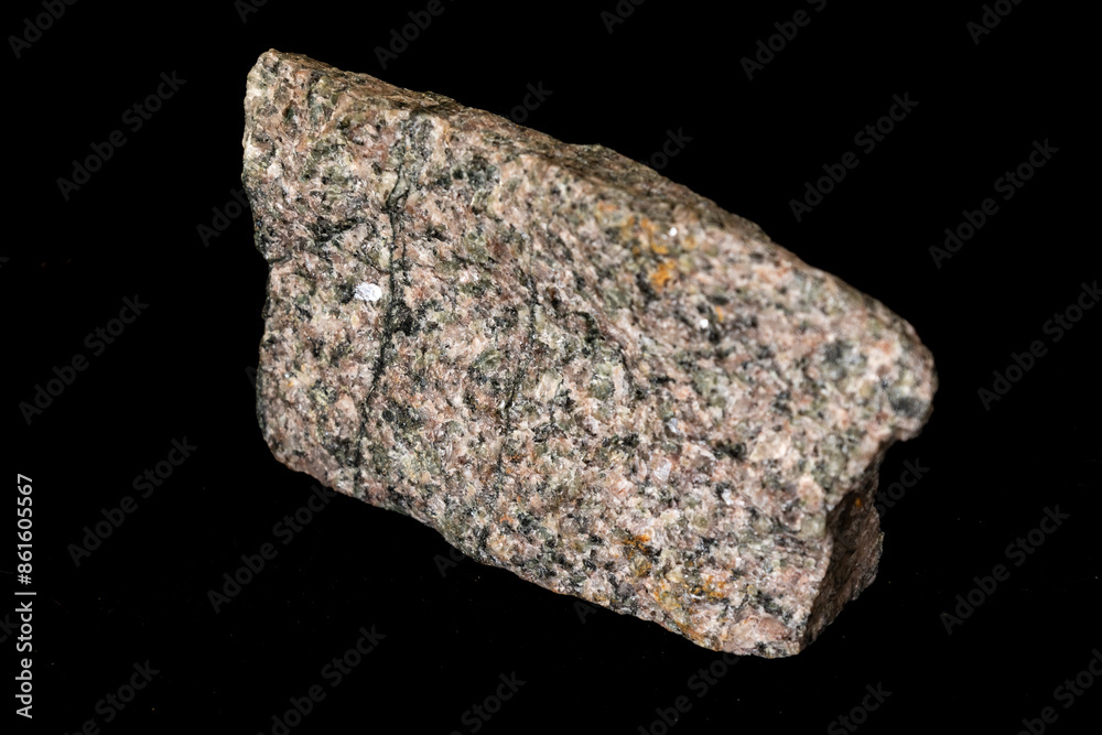 Obraz premium A sample of Archean aged pink and green coloured alkaline granite against a black background