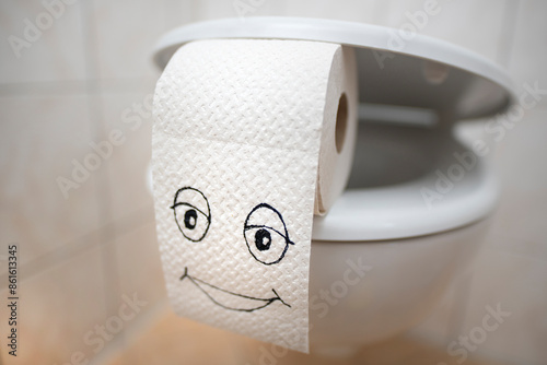 Smiley face on a toilet paper roll.