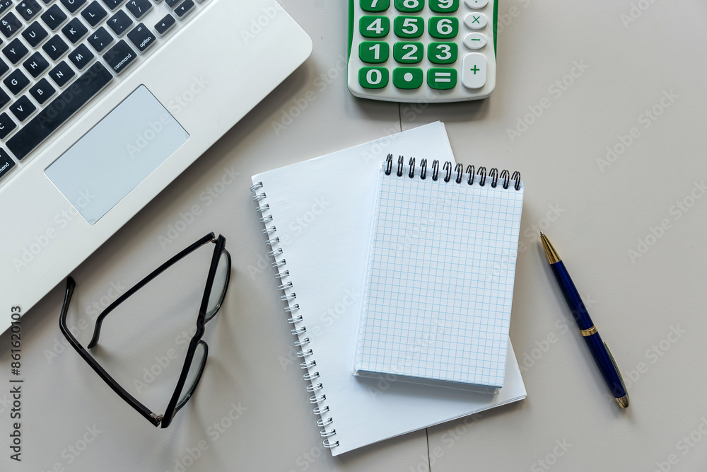 open notepad for notes with pen laptop and calculator on office white desk open notepad for notes with pen laptop and calculator on office white desk