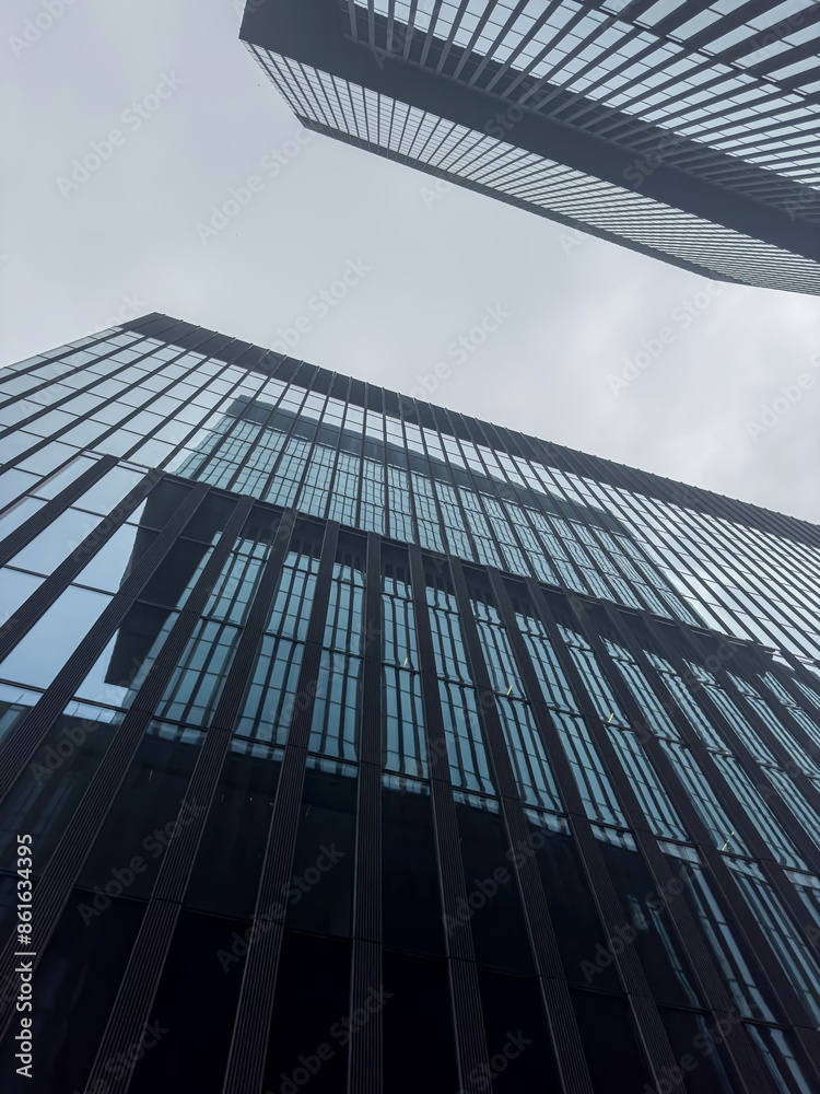 Fototapeta premium Commercial modern city. Bottom up view glass buildings skyscrapers. business concept