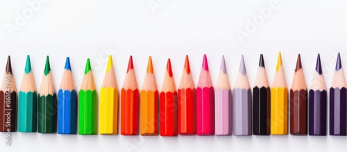Color pencils held against a white backdrop with a creative scene for a copy space image.