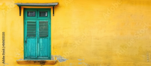Old Asian style vintage wooden window / green door / yellow wall of colorful house. with copy space image. Place for adding text or design