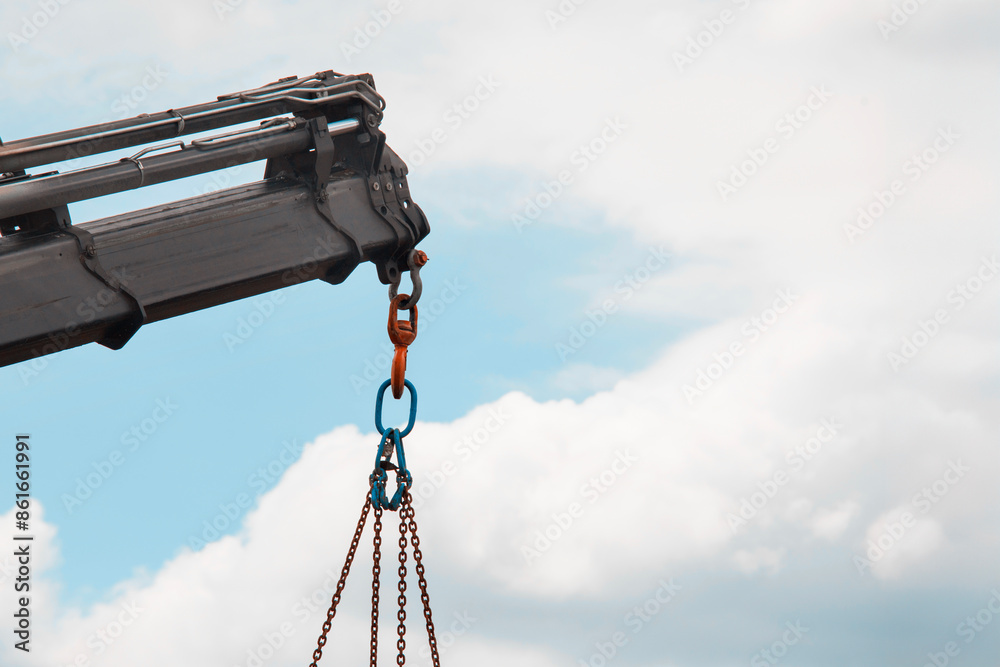 Close-Up of Crane Hook and Chains Against Cloudy Sky Close-Up of Crane Hook and Chains Against Cloudy Sky