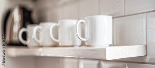 White coffee mugs hanging o...