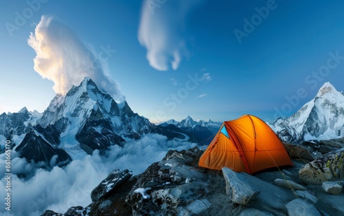 Serene Dawn at a High-altitude Himalayan Campsite with Bright Orange Tent on Rocky Ledge