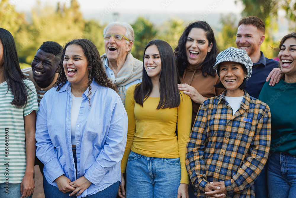 Crowd of multi generational people having fun together outdoor - Multiracial friends enjoy day at city park together - Community concept Crowd of multi generational people having fun together outdoor - Multiracial friends enjoy day at city park together - Community concept