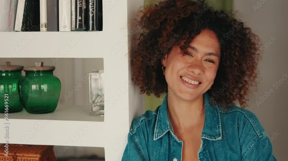 Close-up smiling young woman looking at camera In living room Close-up smiling young woman looking at camera In living room