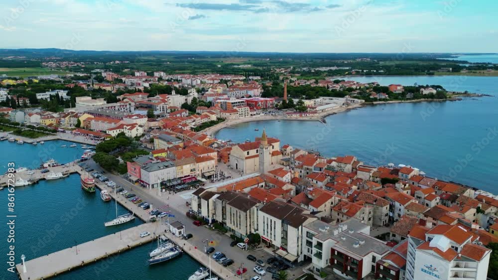 A stunning aerial view of Umag, a charming coastal town in Istria, Croatia. Known for its beautiful beaches, historic architecture, and vibrant marina, Umag offers a perfect blend of relaxation A stunning aerial view of Umag, a charming coastal town in Istria, Croatia. Known for its beautiful beaches, historic architecture, and vibrant marina, Umag offers a perfect blend of relaxation