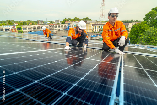 Wallpaper Mural engineer man inspects construction of solar cell panel or photovoltaic cell by electronic device. Industrial Renewable energy of green power. factory worker working on tower roof. Torontodigital.ca