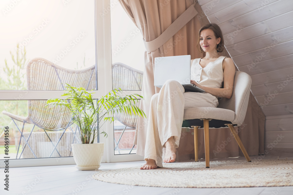 Beautiful stylish woman is working on laptop in modern house. Remote working. Blogger or influencer. Online internet job. Beautiful stylish woman is working on laptop in modern house. Remote working. Blogger or influencer. Online internet job.