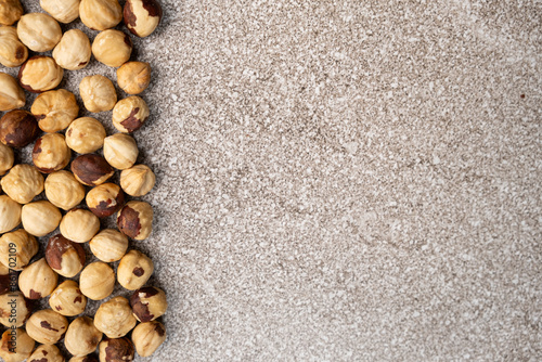 Roasted hazelnuts on a gray stone background top view, place for text