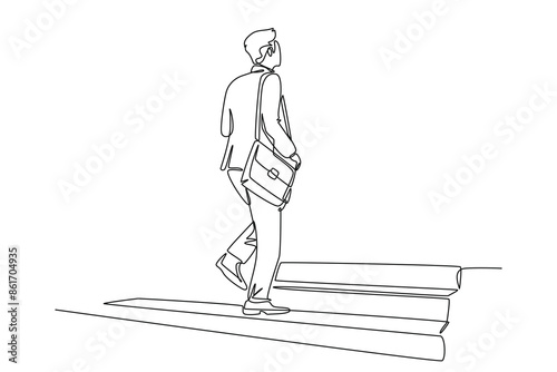 Continuous one line drawing back view of young male manager walking relax on city street to go to the office while holding document. Urban commuter worker. Single line draw design vector illustration