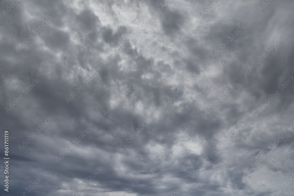 Obraz premium Gray clouds cover the sky, light through gray clouds, gray fall sky, light through a dense shroud of clouds