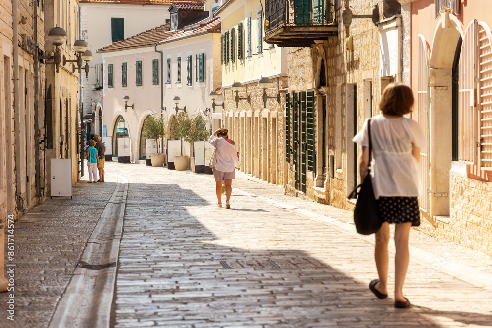 Half-empty cobbled street of old town, illuminated by the midday sun. Summer heat of Mediterranean climate and siesta Half-empty cobbled street of old town, illuminated by the midday sun. Summer heat of Mediterranean climate and siesta