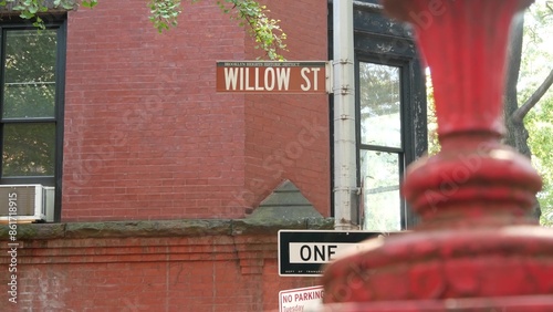 New York City crossroad, Brooklyn Heights Willow street intersection, one way road sign. Residential district architecture, red brick house, United States. NYC police call box and corner text roadsign