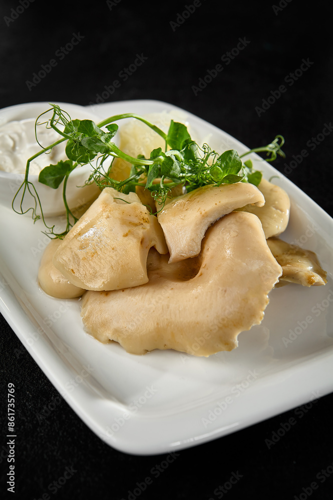 Salted Milk Cap Mushrooms with Sour Cream on a White Plate Salted Milk Cap Mushrooms with Sour Cream on a White Plate