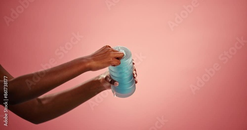 Hands, studio and toy for pleasure with lube for wellness, discreet and waterproof for stimulation. Person, privacy and adult product with erotic accessory, intimate and mockup space in background.