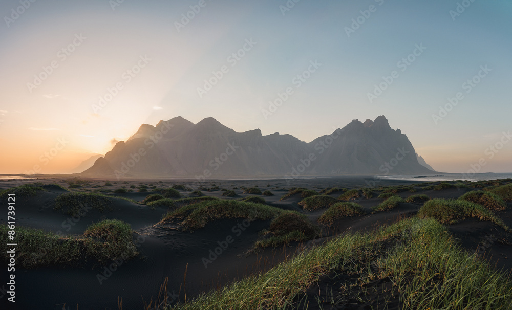 Stunning panoramic view of Vestrahorn, an impressive 454 metres tall mountain. It faces out to the sea on its southern side and is surrounded by a black sandy coastline. Iceland.
