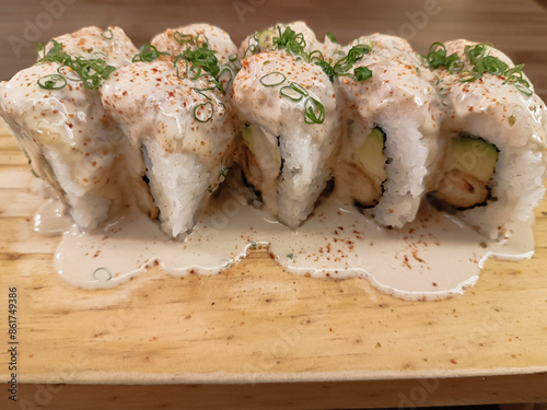 Table of aceviched Makis decorated with Chinese onion in small cuts, really appetizing photo