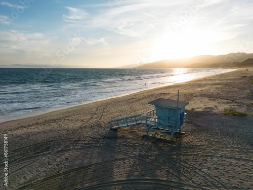 Serene beach landscape with a lifeguard tower at sunset in Santa Monica beach, California