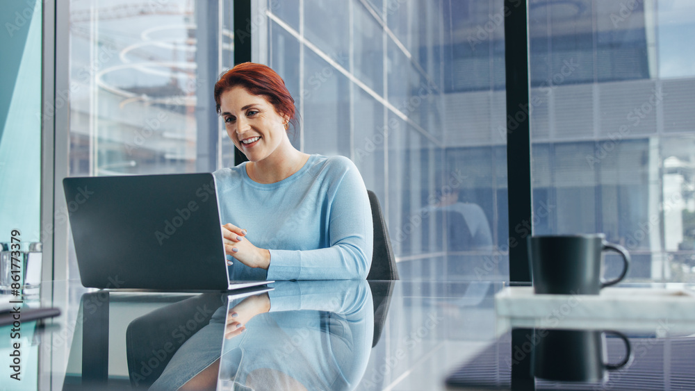 Female business executive having a virtual meeting using a laptop Female business executive having a virtual meeting using a laptop